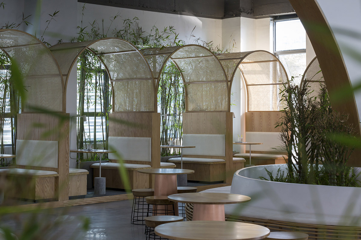 Copper-colored staircase and mini-bamboo trees provide tropical interior for this office in Vietnam