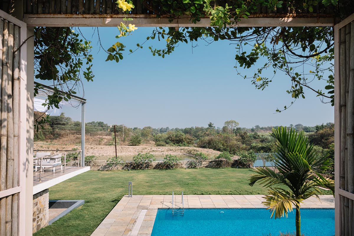 Weekend home is clad in bamboo screens that create a rustic appearance on the outskirts of Pune