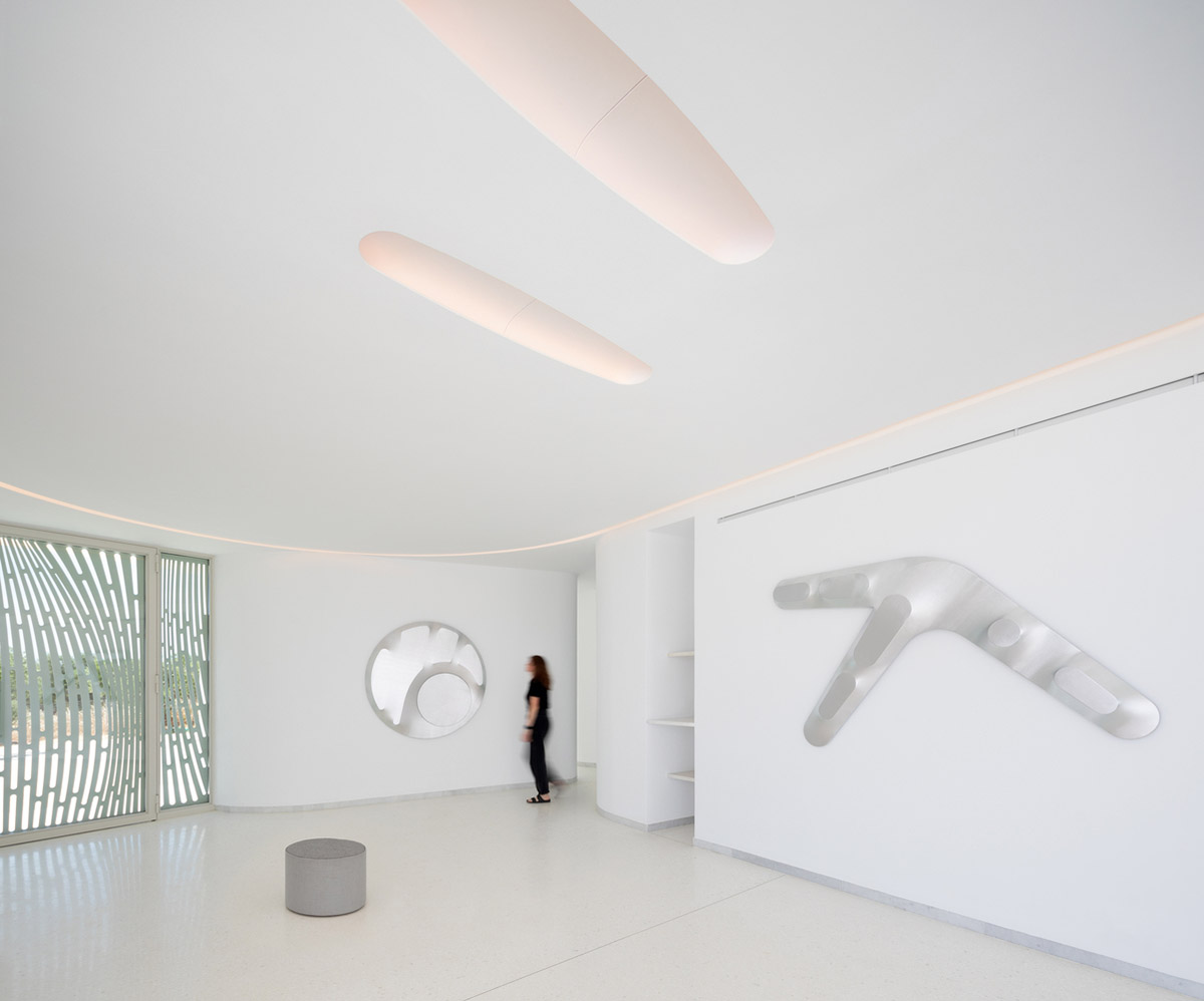 LASSA architects forms rounded walls for house to provide meditative courtyards in Greek olive grove