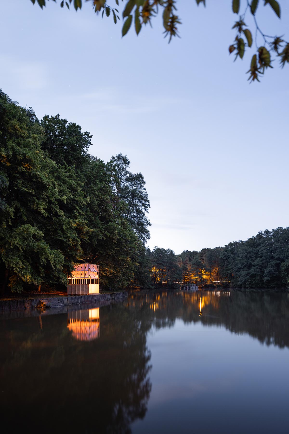 GRAU Architects built a tea house pavilion giving a ceremonial impression overlooking a lake 