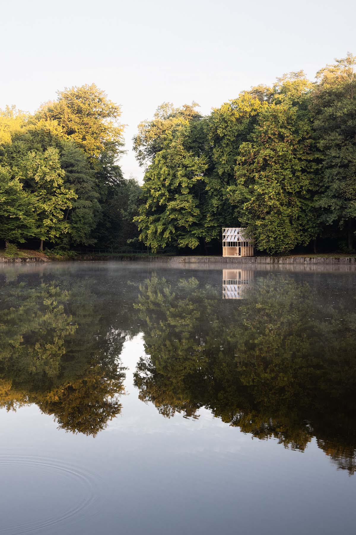 GRAU Architects built a tea house pavilion giving a ceremonial impression overlooking a lake 
