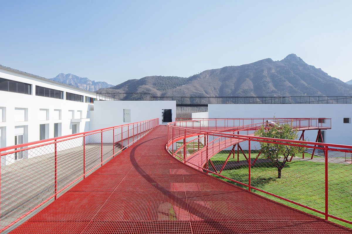 REDe Architects and Moguang Studio add red circular platform to renovated youth activity center
