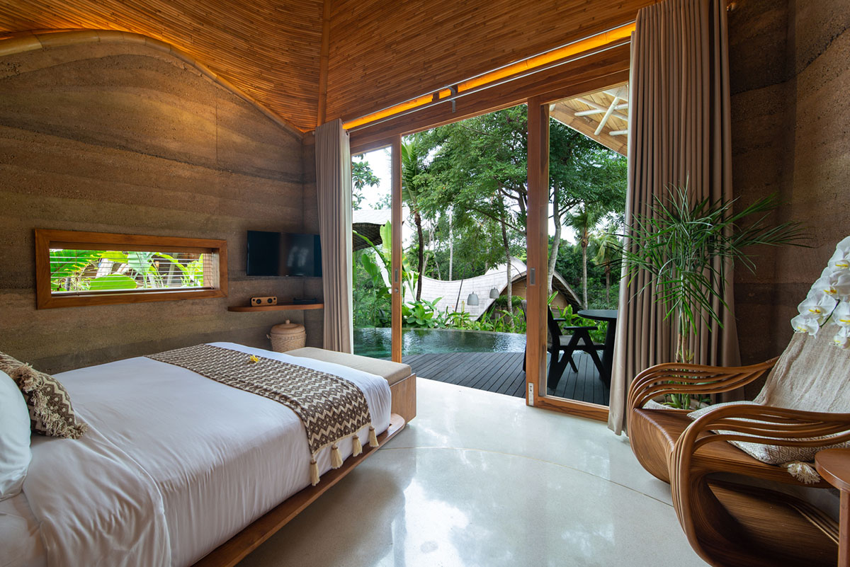 Undulating bamboo roofs wrap this wellness retreat in a lush forest of Bali