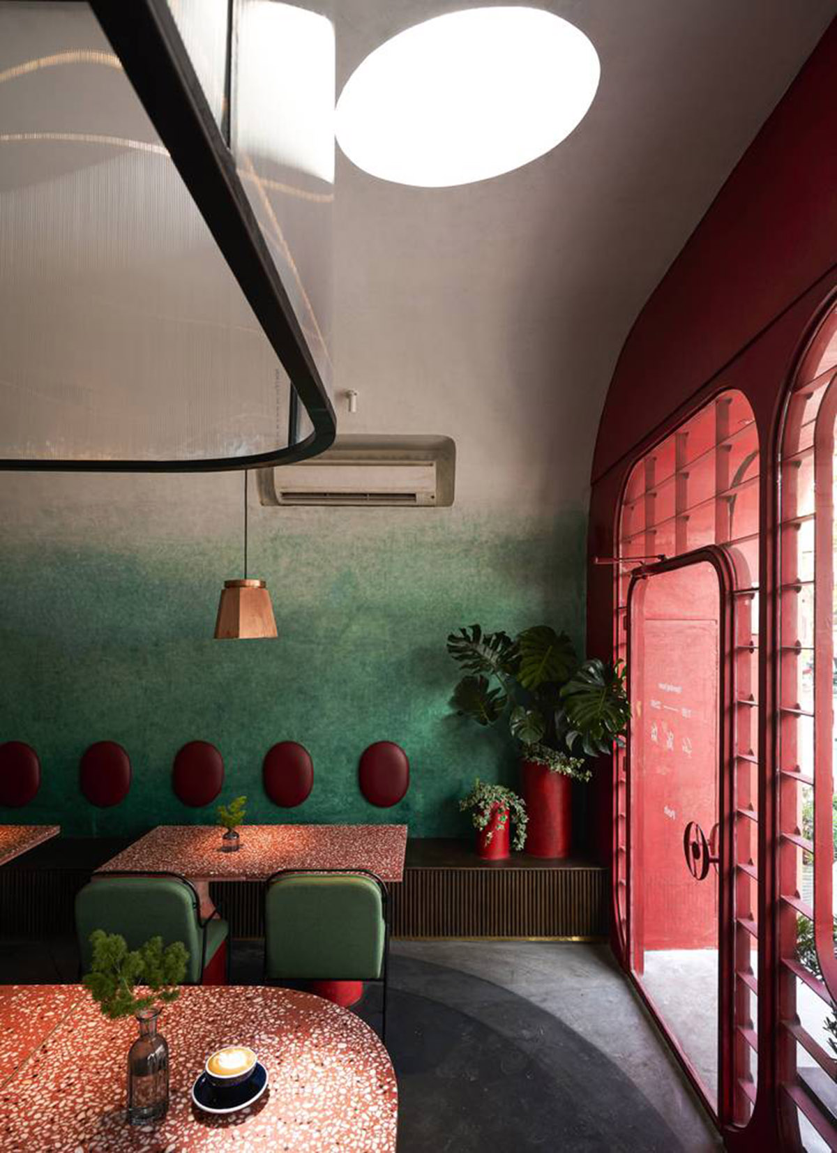 Red5studio built cafe evoking a retro spirit with hues of red colors and lights in Vietnam