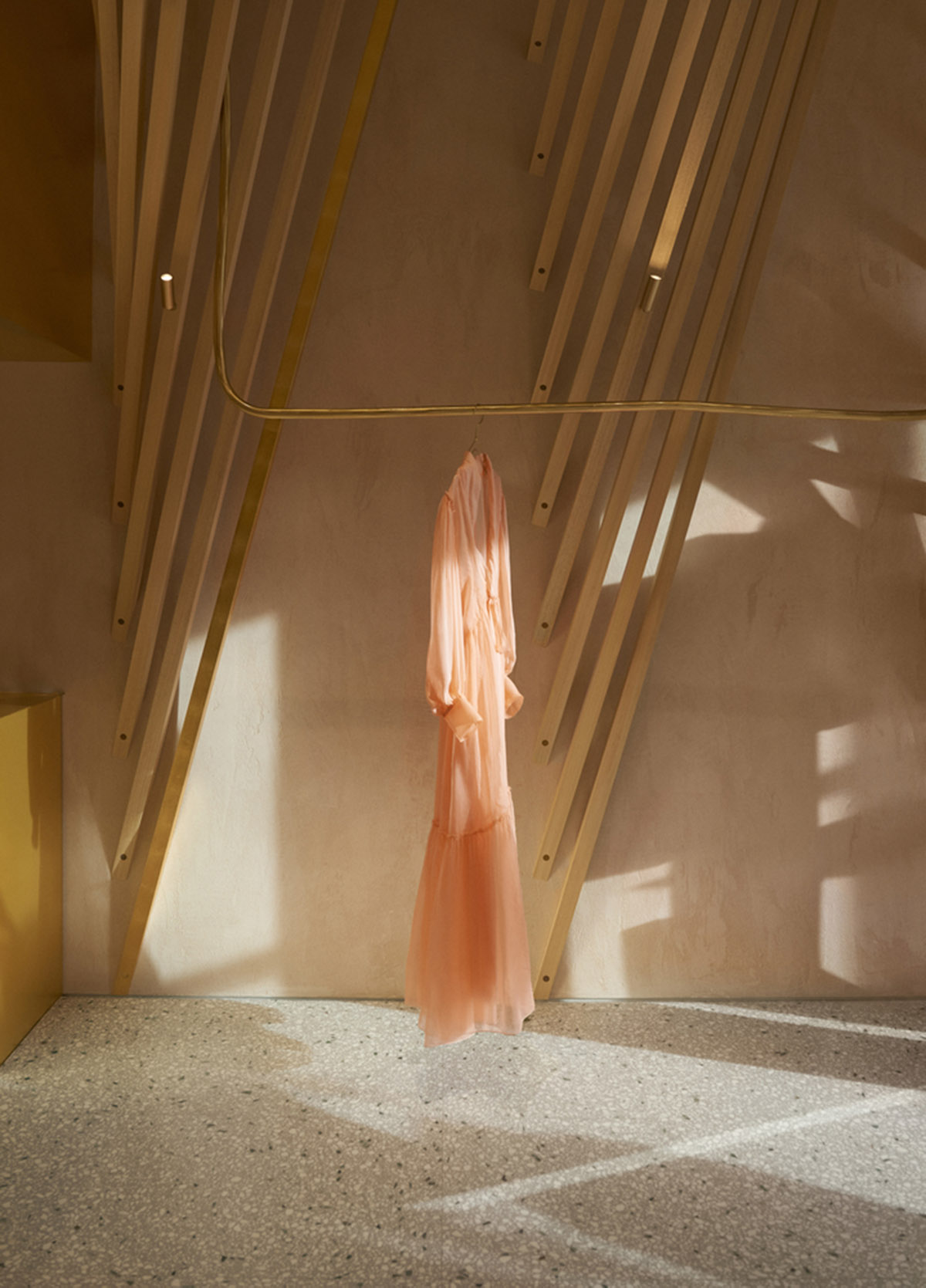 Golden and powder-colored details dominate forte_forte forte dei Marmi boutique in Italy