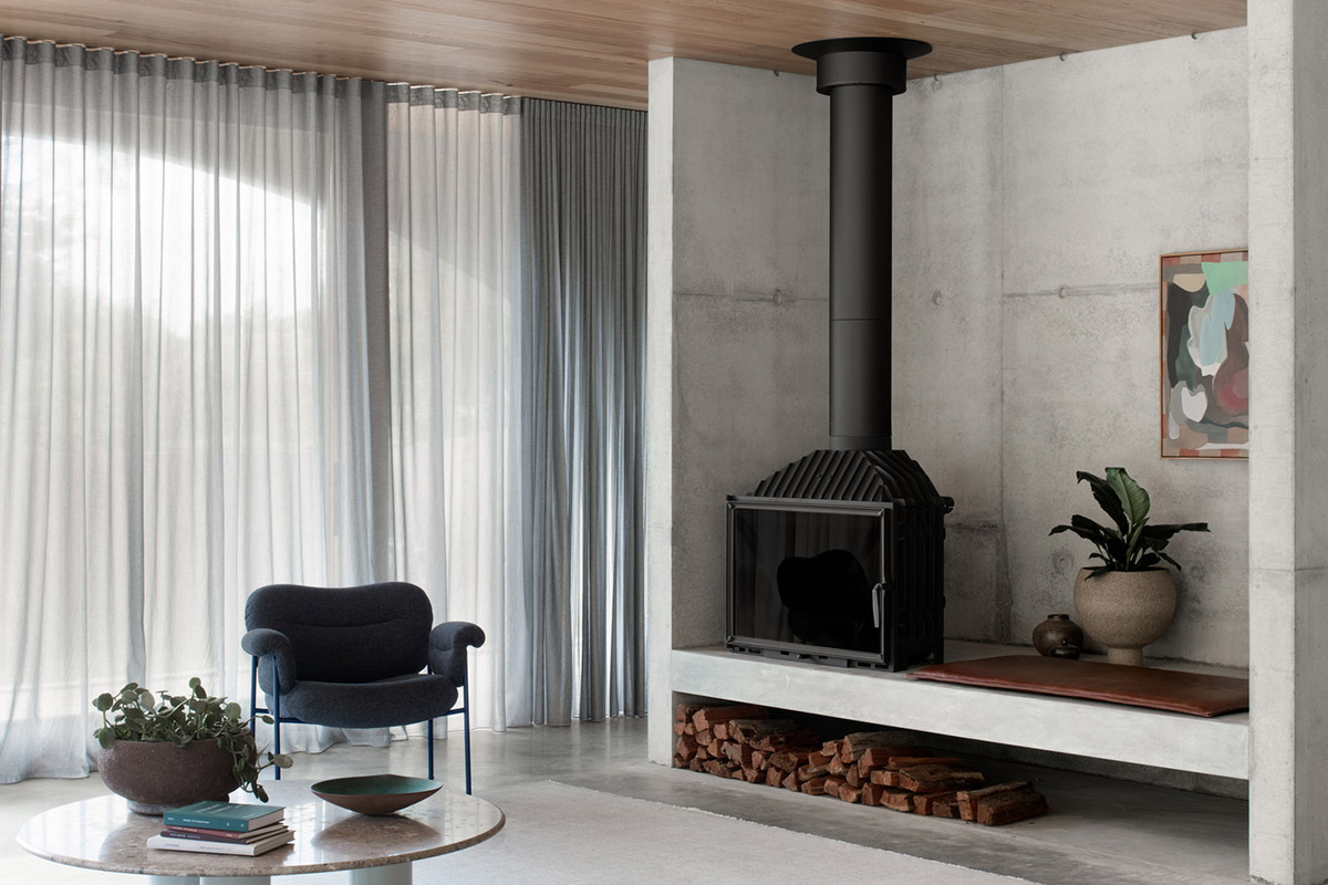 Arched concrete walls wrap a pair of houses as a secondary shelter in Australia