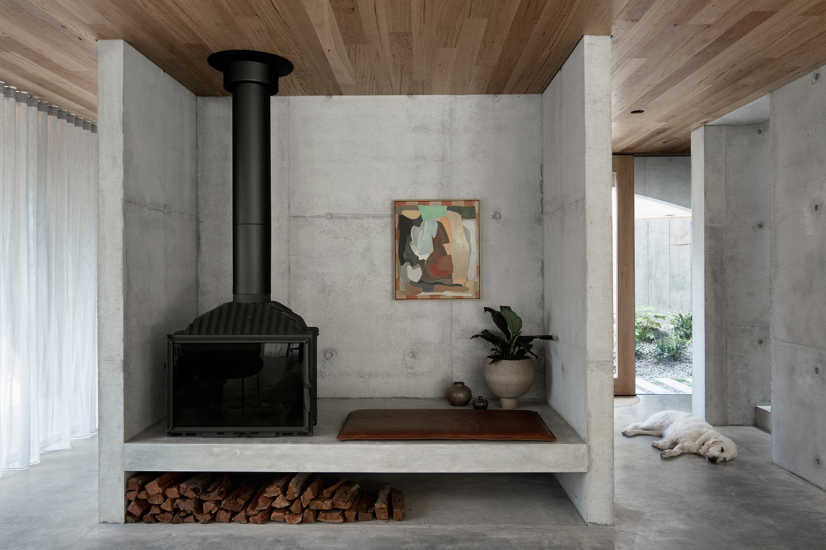 Arched concrete walls wrap a pair of houses as a secondary shelter in Australia