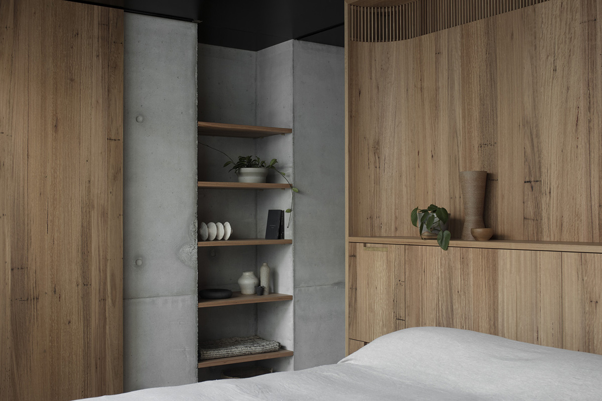 Arched concrete walls wrap a pair of houses as a secondary shelter in Australia