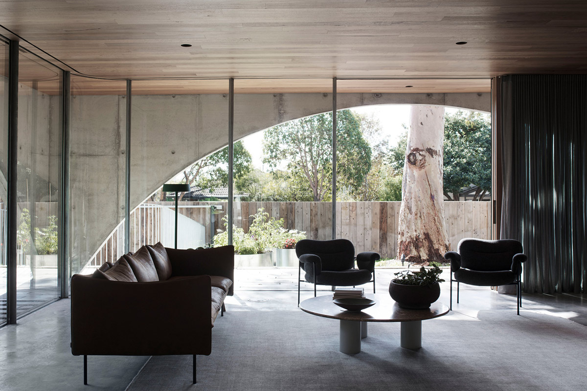 Arched concrete walls wrap a pair of houses as a secondary shelter in Australia