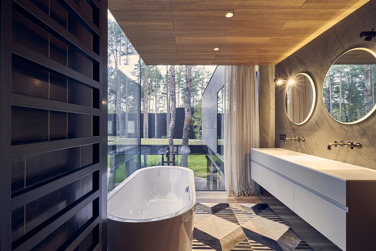 Przemek Olczyk Mobius Architekci completes circle wood house in a pine forest of Poland