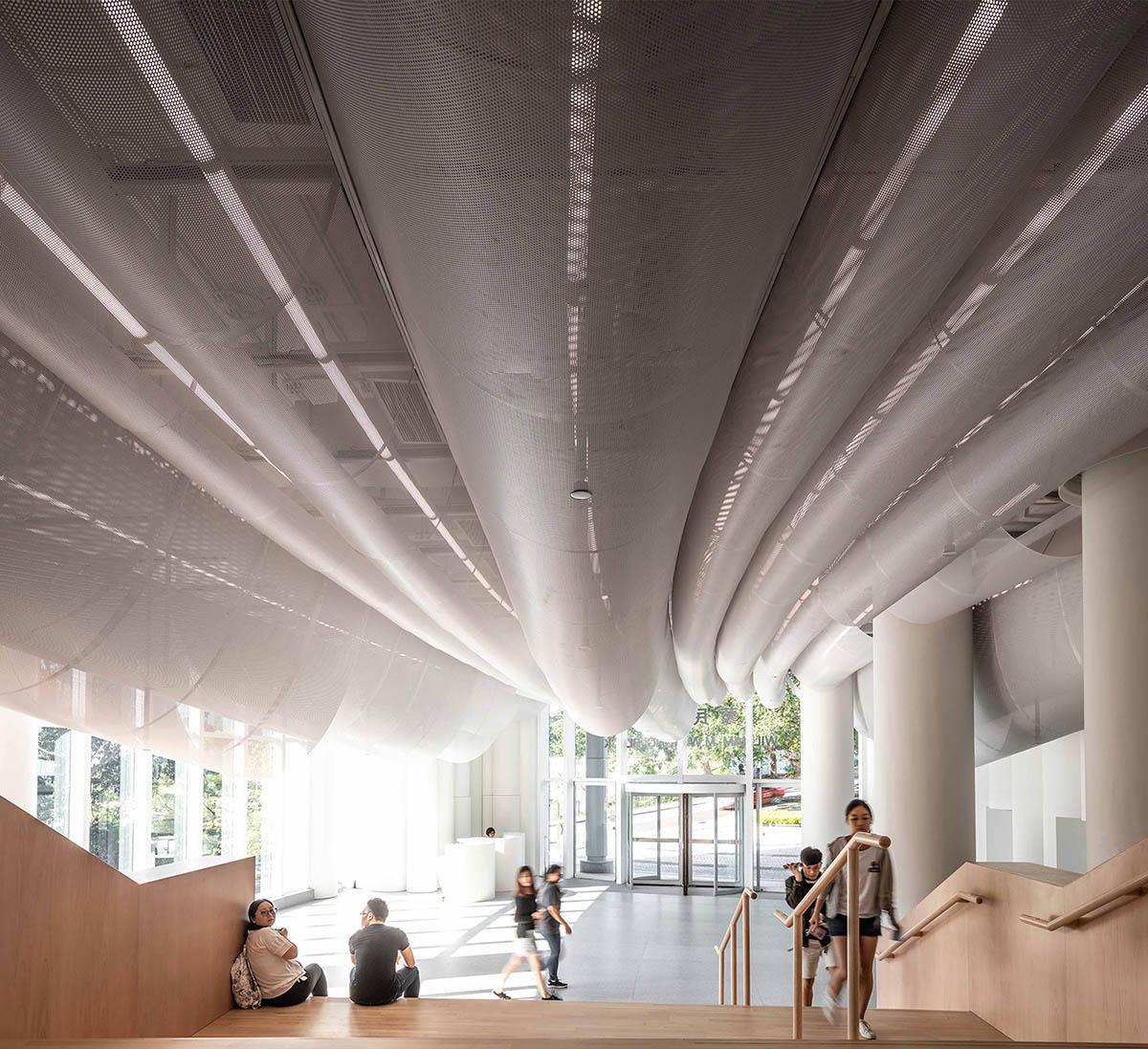 Atelier Nuno Architects suspends tubular aluminum panels from the ceiling of a lobby in Hong Kong