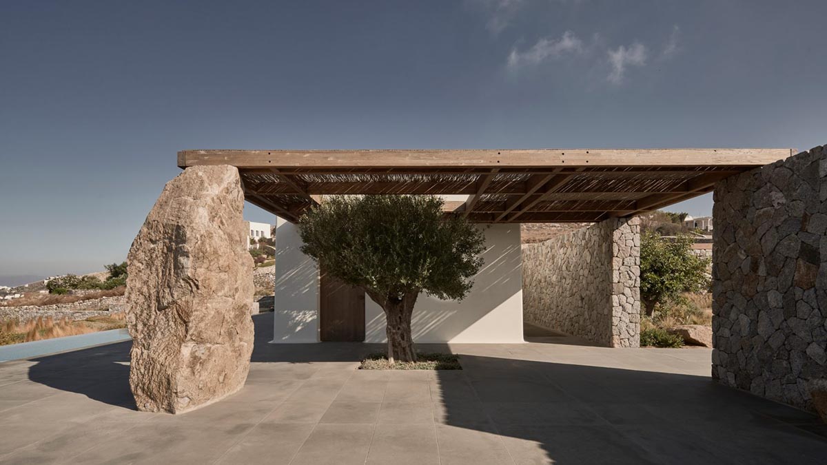 K Studio built small holiday villa with round-edged volumes and shading elements in Mykonos