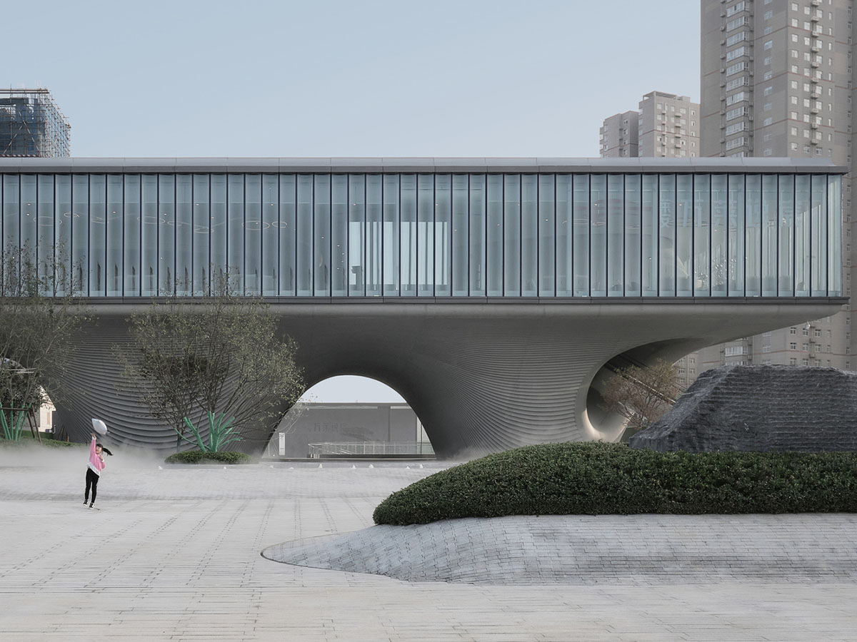 Community Center in Xi’an is raised on sculptural base that features a rippling effect