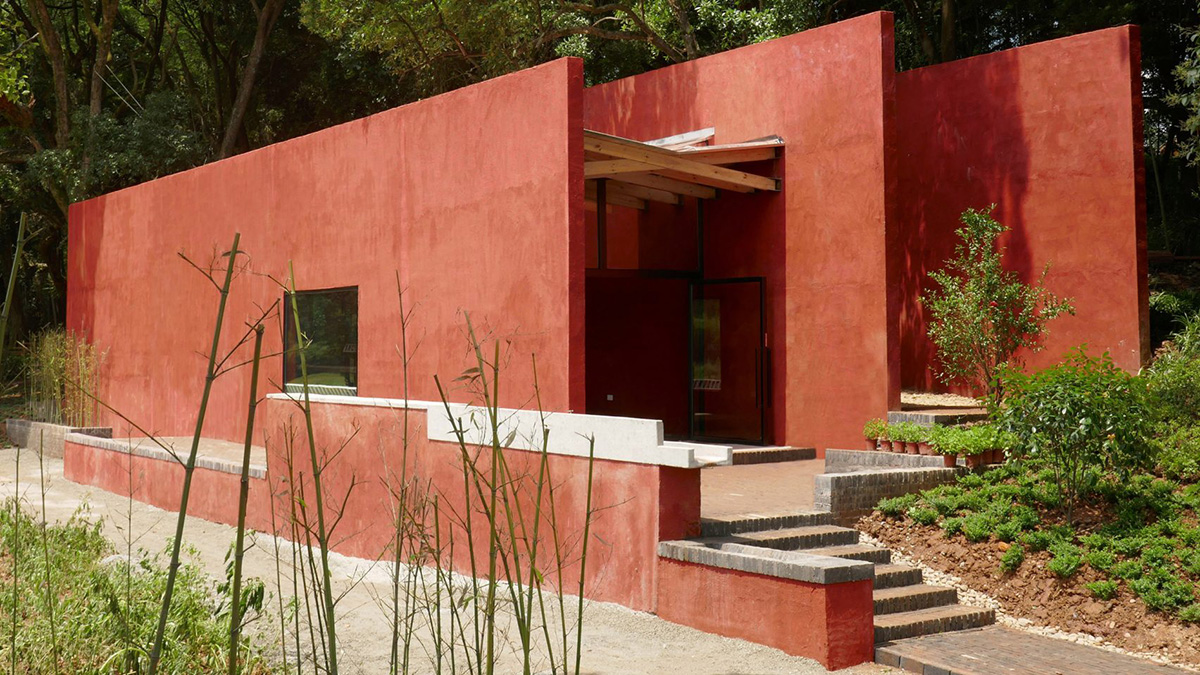 Children attend teaching courses in between red-colored free standing walls in rural village of China