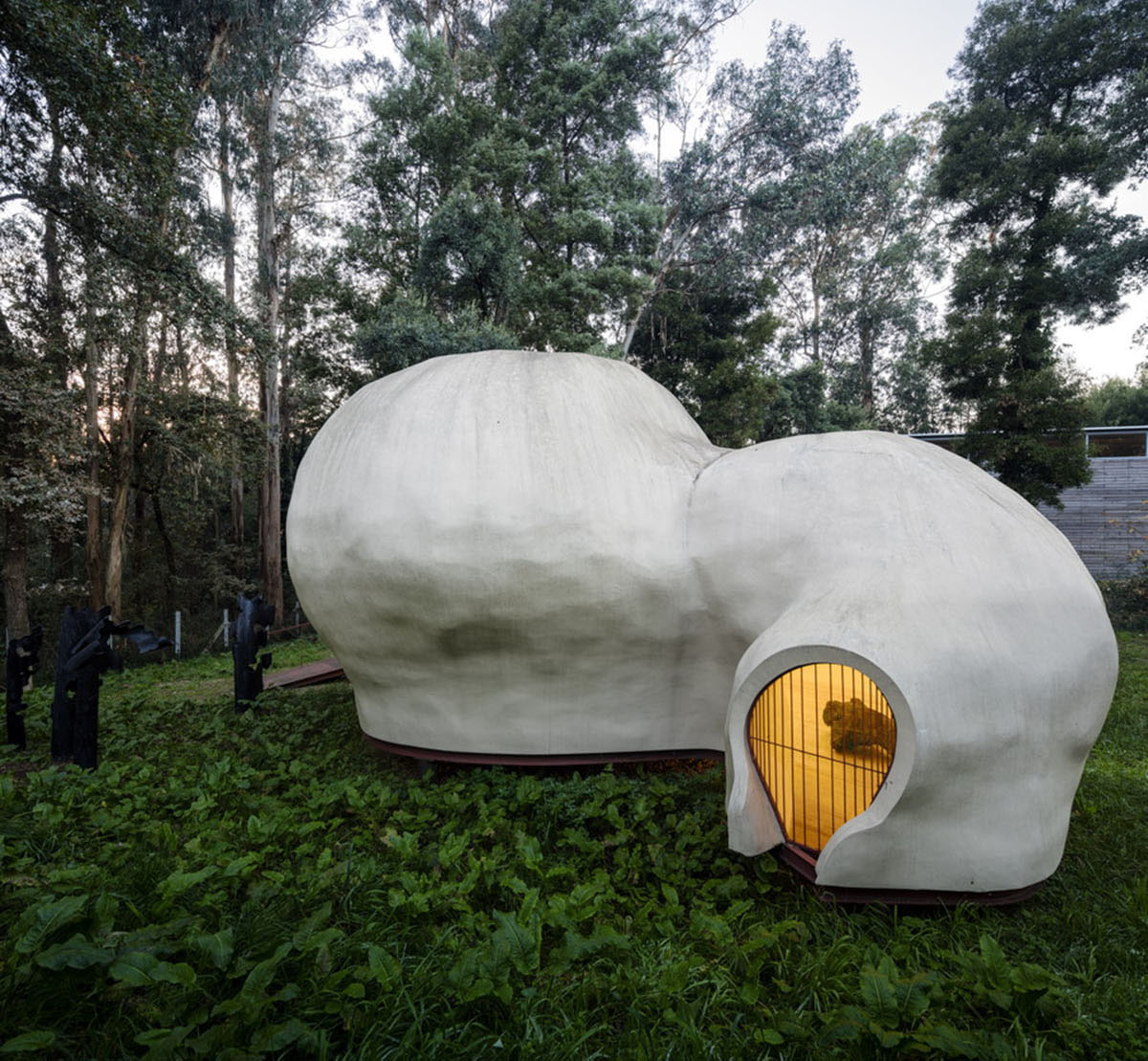 Super small cave-like art gallery by FCC Arquitectura built on lush green in Portugal