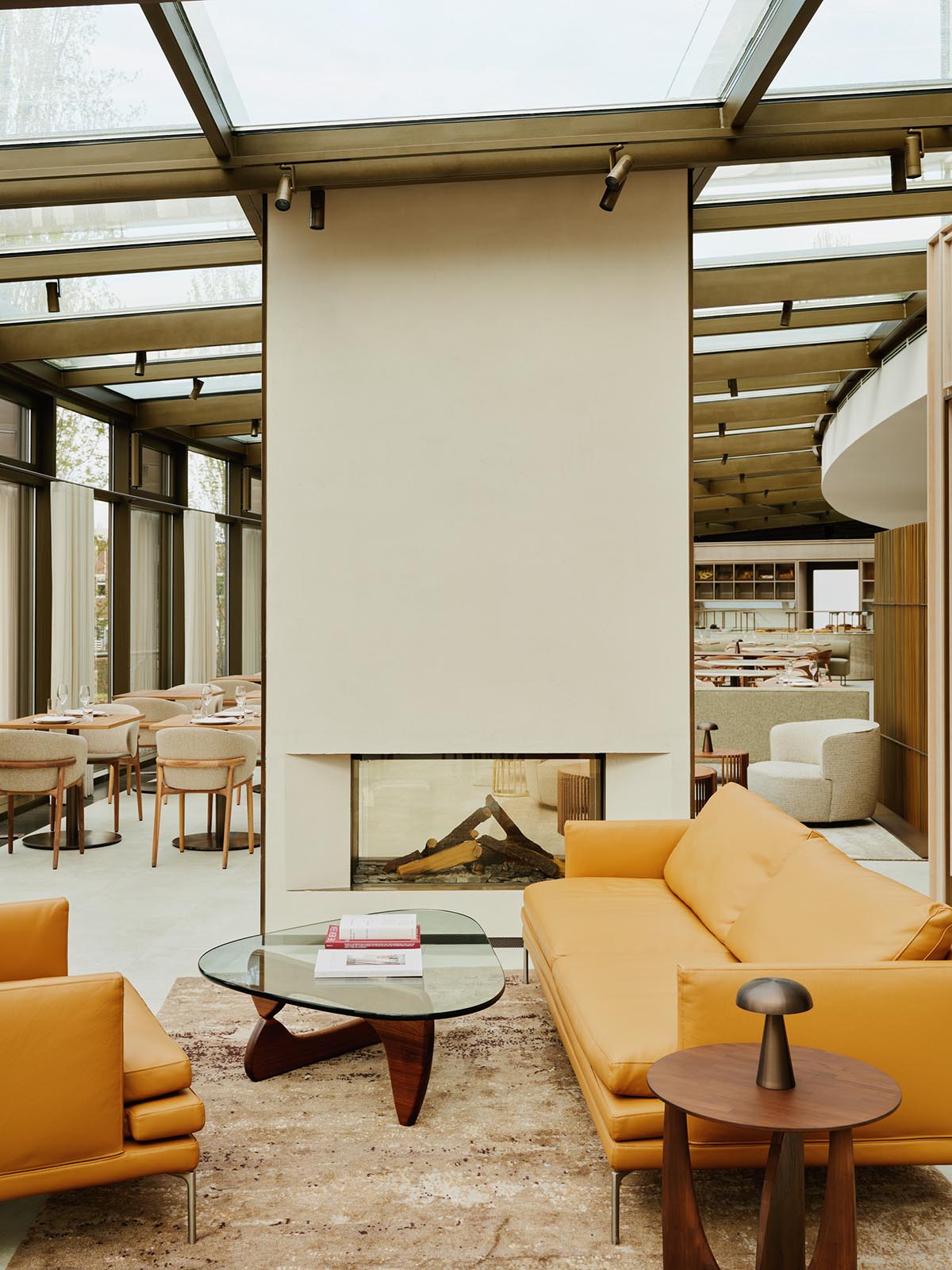 HENN creates interiors of restaurant that evokes sandy dunes with warm colored palette in Germany