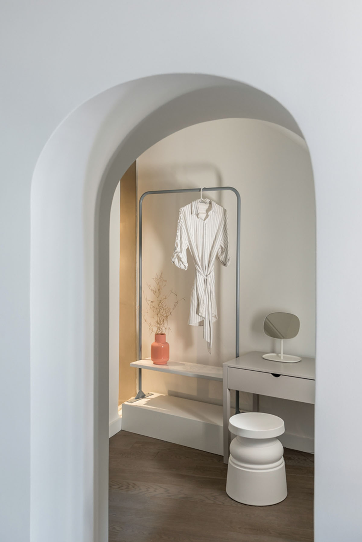 Kapsimalis Architects built castle-like hotel almost disappearing it on a steep hillside of Oia