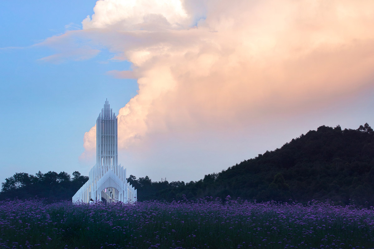 A church made of thousands of white thin beams looks like suspended in the air in lavender field