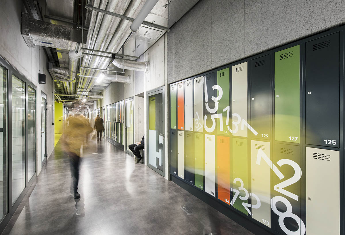 Huge tribunes invite students to sit and experience the courtyard in Warsaw's Akademeia High School