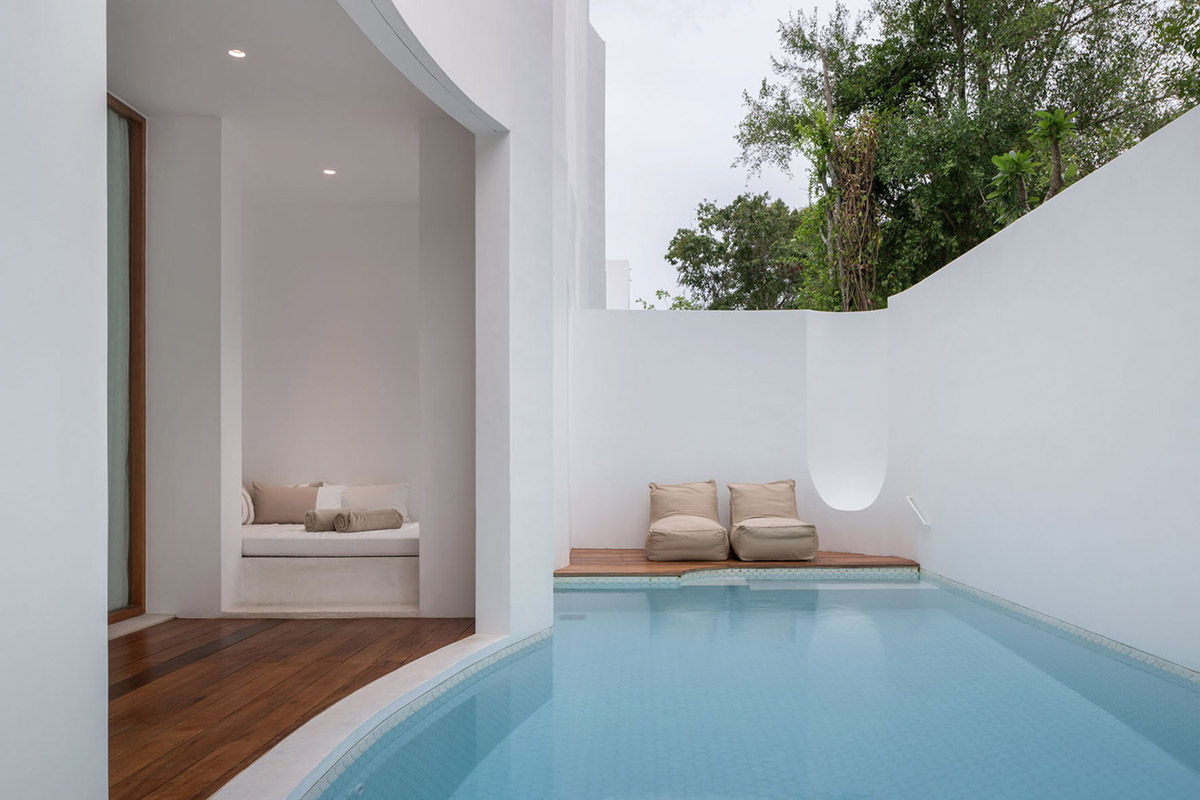 onion combines white concave and convex walls with colorful surfaces for beach resort in Thailand