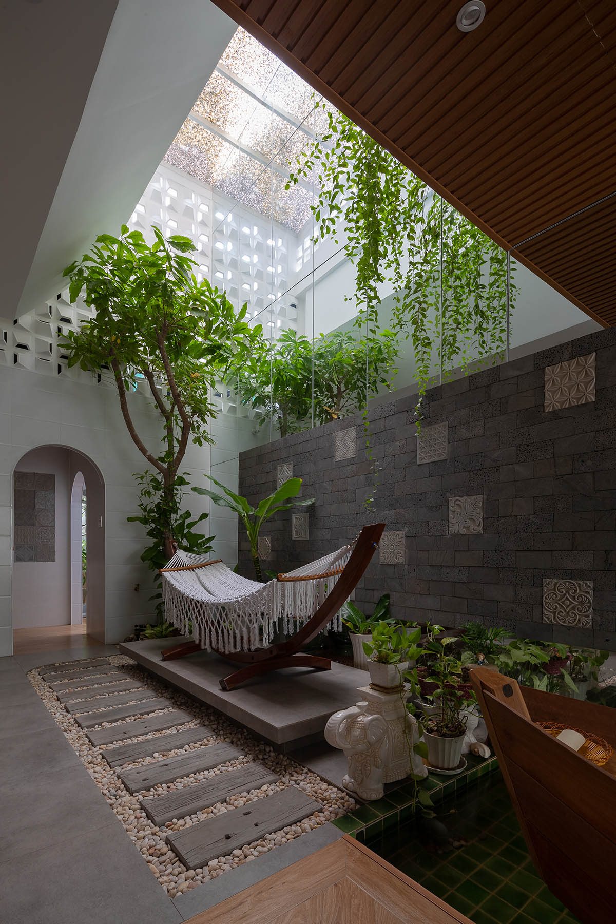 CoCo House, inspired by animated film, is clad in glass brick façade with wavy patterns in Vietnam