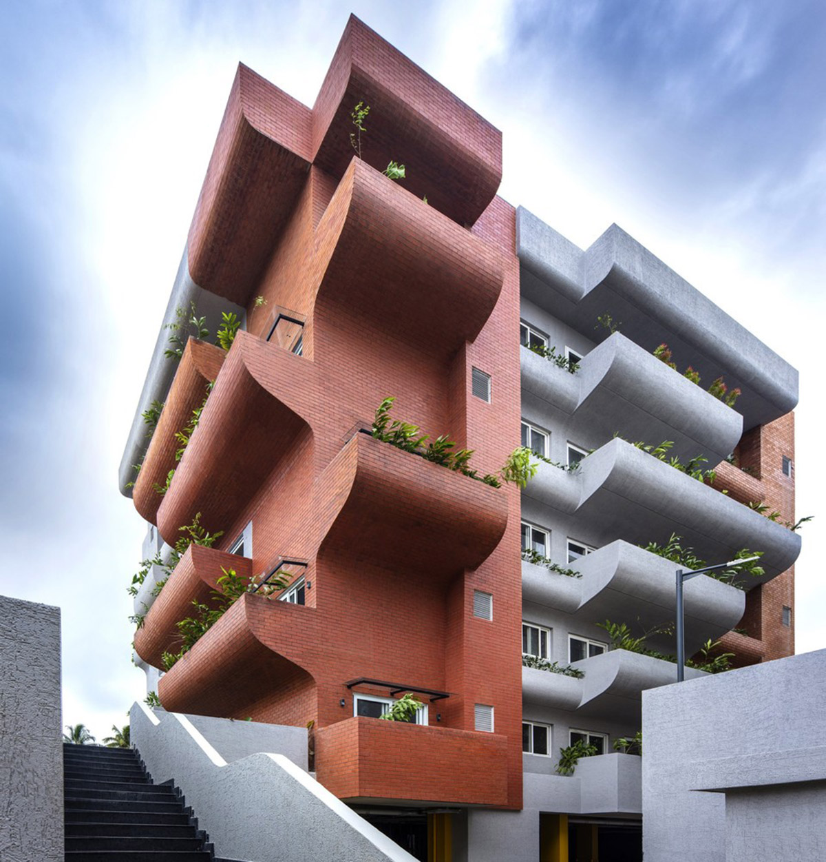 Fluid balconies for this housing help plants to grow comfortably designed by The Purple Ink Studio