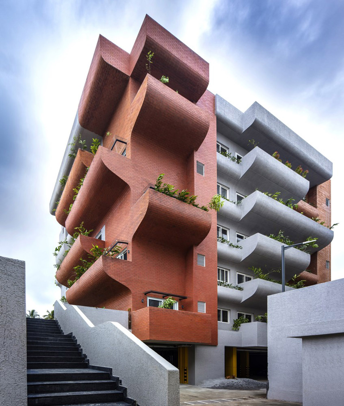 Fluid balconies for this housing help plants to grow comfortably designed by The Purple Ink Studio