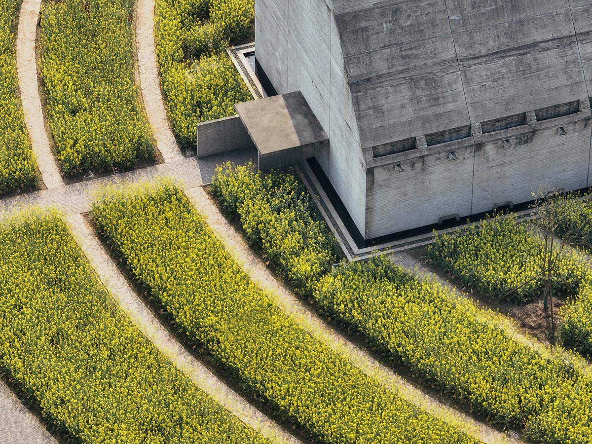 Concrete Land Museum made of pitched roof overlooks sorghum fields on Island Hopping Village