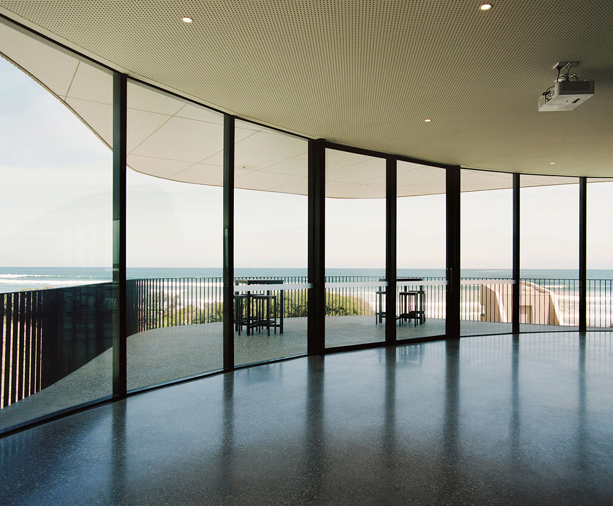 Wood Marsh completes surf club with timber rounded corners echoing ocean and eroded dunes