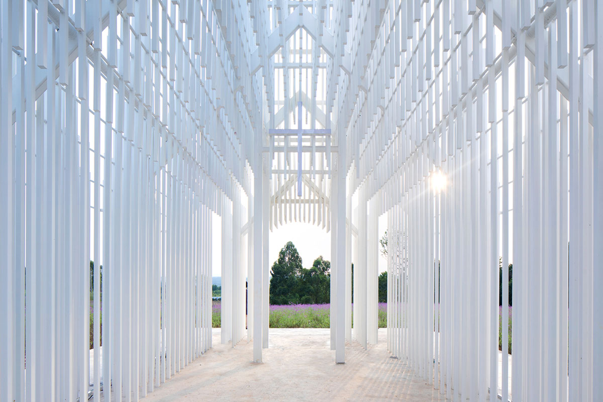 A church made of thousands of white thin beams looks like suspended in the air in lavender field