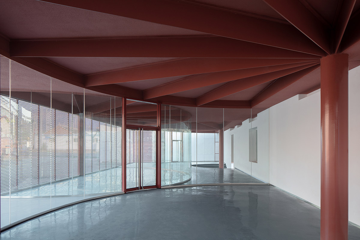 REDe Architects and Moguang Studio add red circular platform to renovated youth activity center