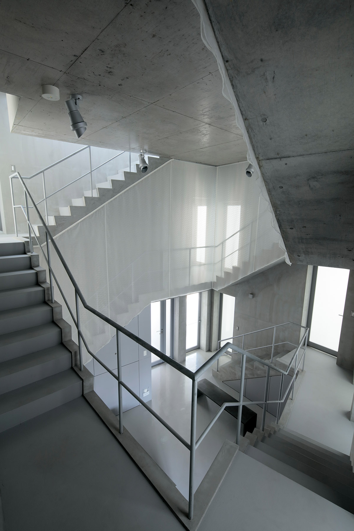 TA+A completes concrete Tokyo Gasshuku-jo share house with two concrete spiral staircases