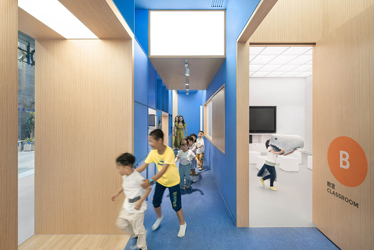 Crossboundaries designs blue sculptural spine as lively interface for Qkids English Center in China