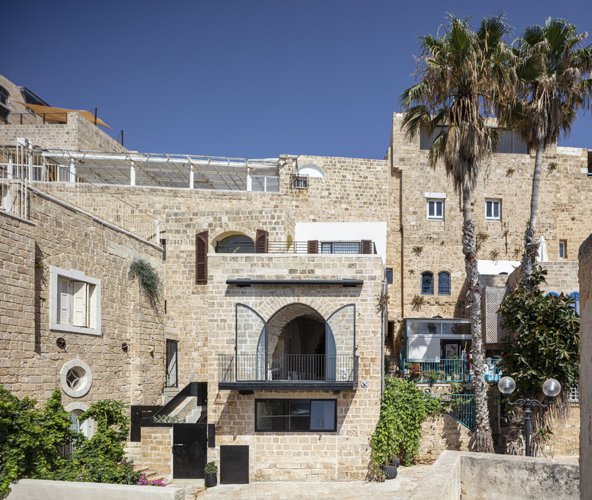Pitsou Kedem Architects creates interior with arched doorways in a historic apartment in Israel