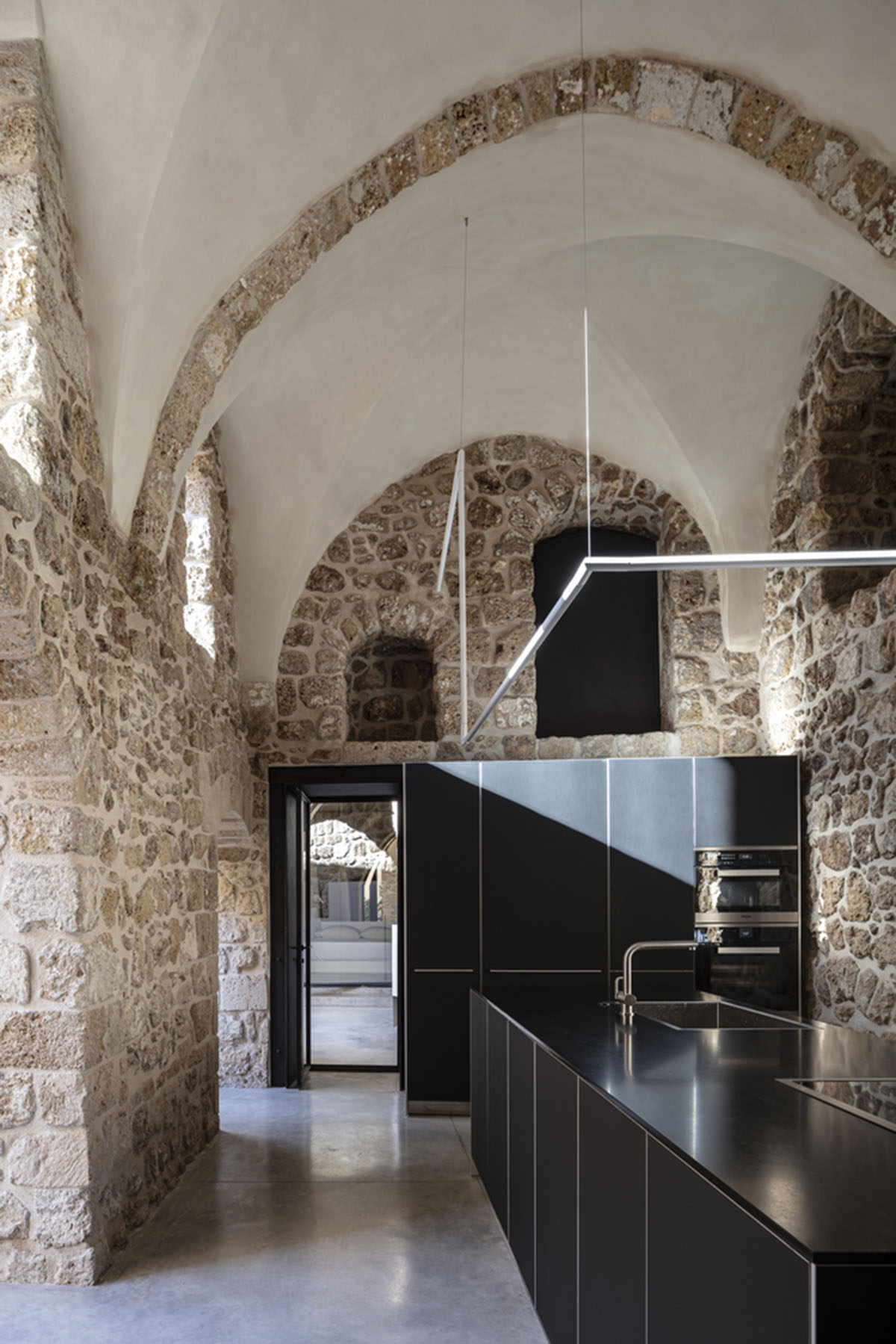 Pitsou Kedem Architects creates interior with arched doorways in a historic apartment in Israel