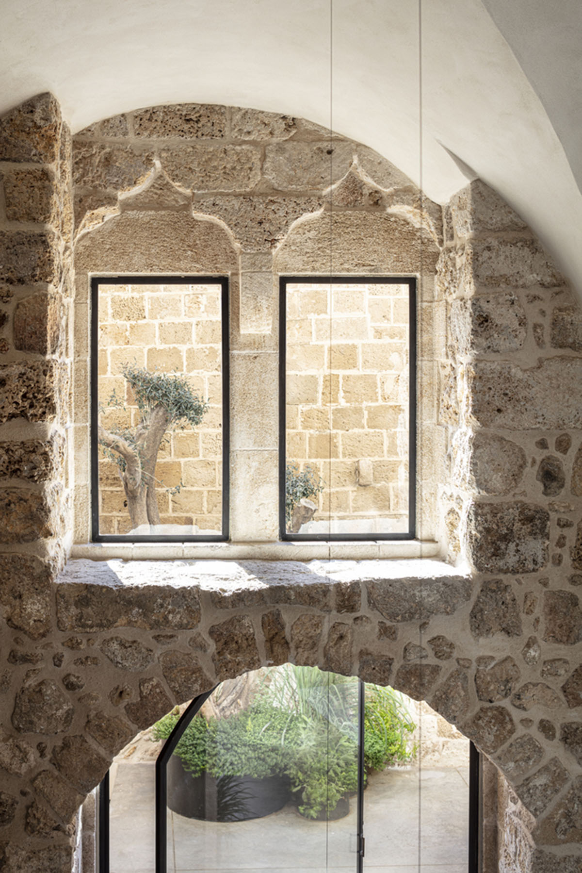Pitsou Kedem Architects creates interior with arched doorways in a historic apartment in Israel