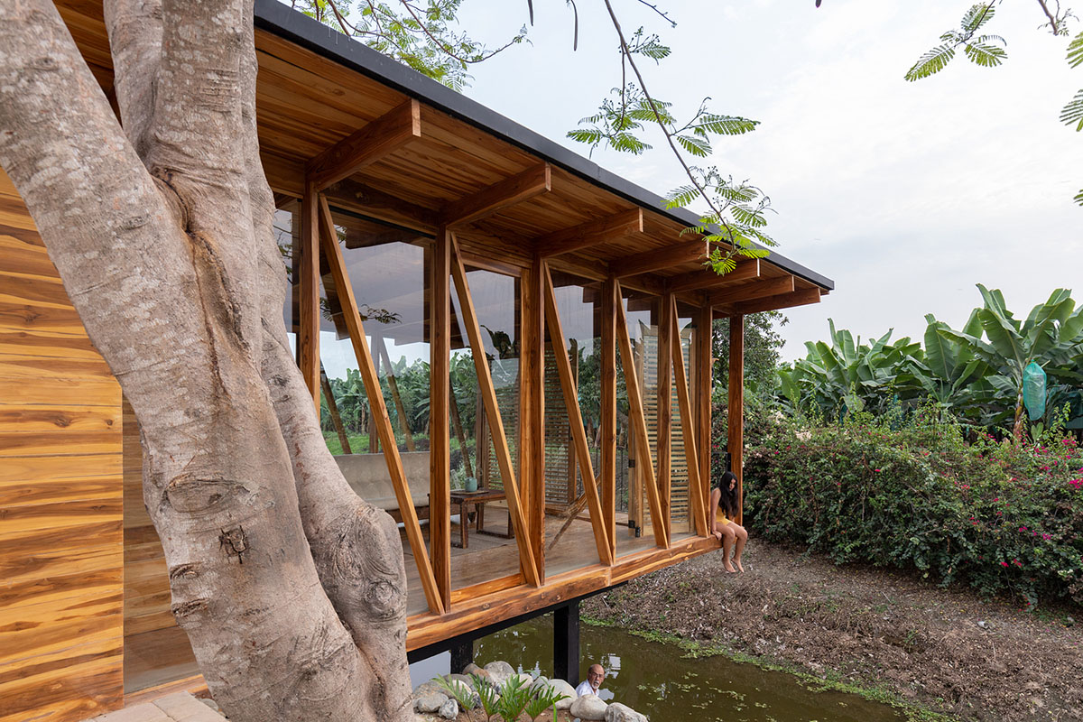 Natura Futura Arquitectura raises timber-framed tea room over a water channel in Ecuador