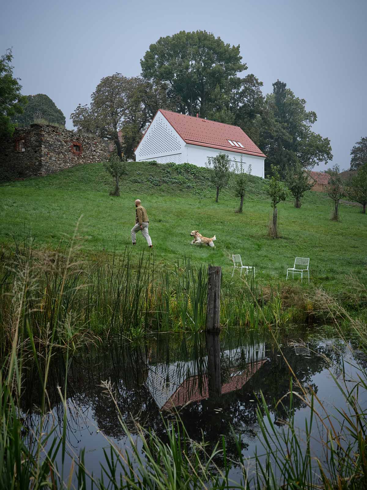 Jan Žaloudek Architekt converts a Baroque barn into a light-filled house with perforated gable wall