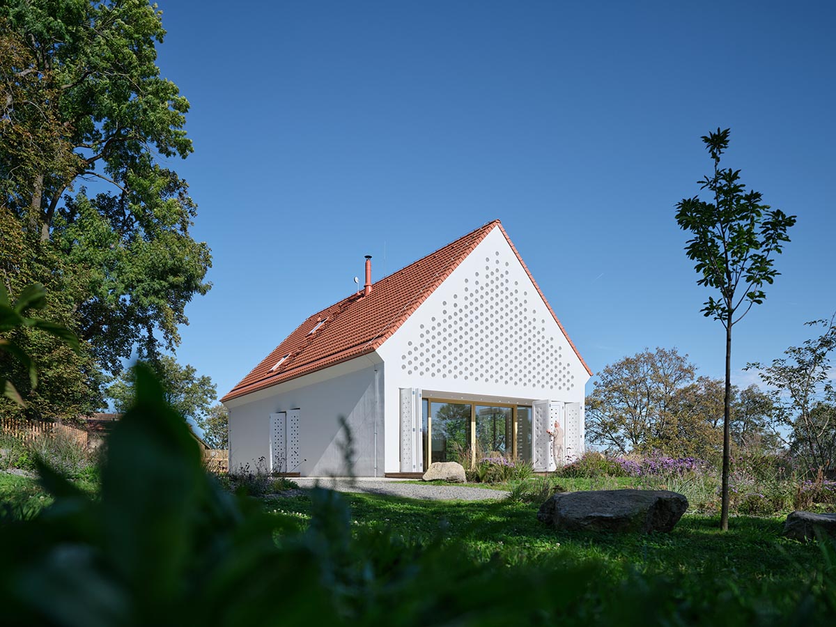 Jan Žaloudek Architekt converts a Baroque barn into a light-filled house with perforated gable wall
