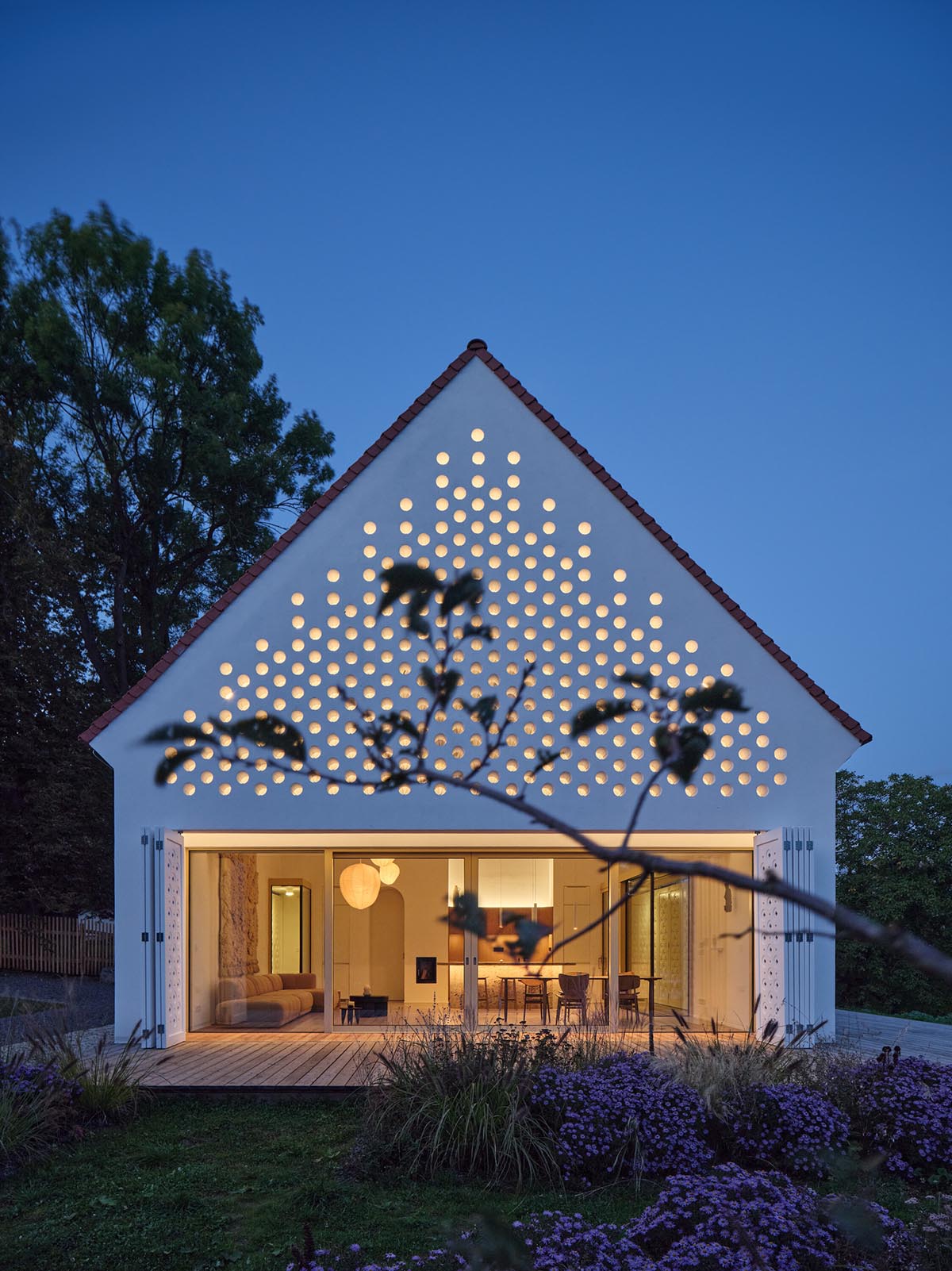 Jan Žaloudek Architekt converts a Baroque barn into a light-filled house with perforated gable wall