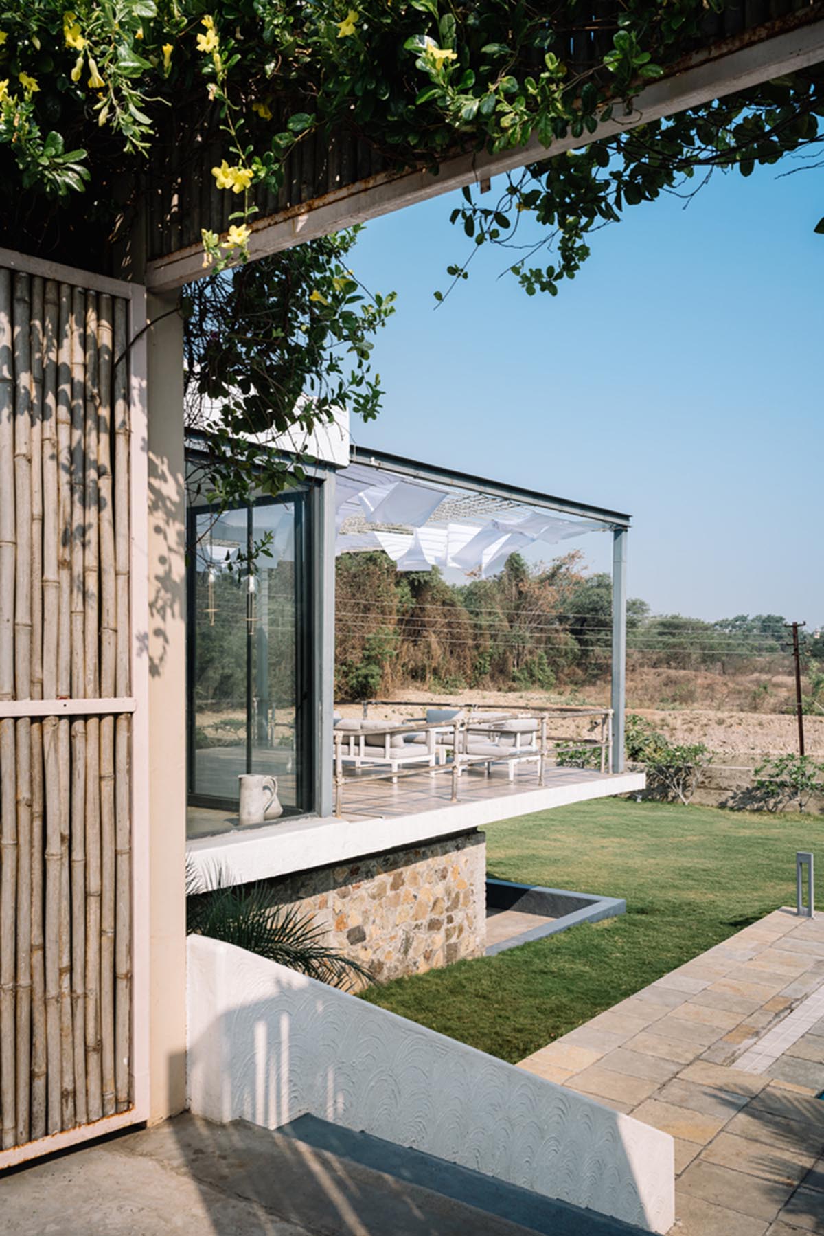 Weekend home is clad in bamboo screens that create a rustic appearance on the outskirts of Pune