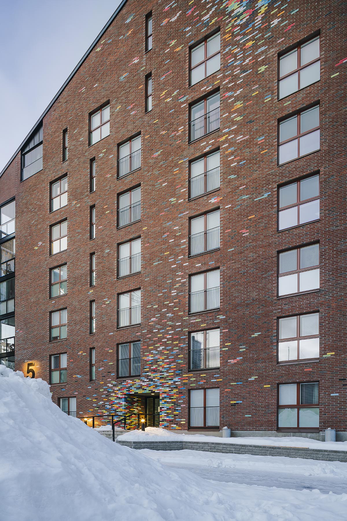 JKMM Architects completes new housing featuring colorful brick patterns on facade in Finland