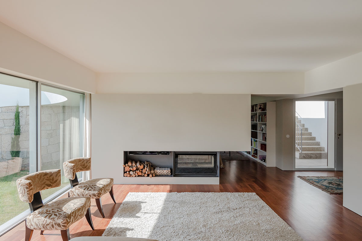 NOARQ designs smooth curvy-roof for Portuguese house to adapt to topography and create courtyards