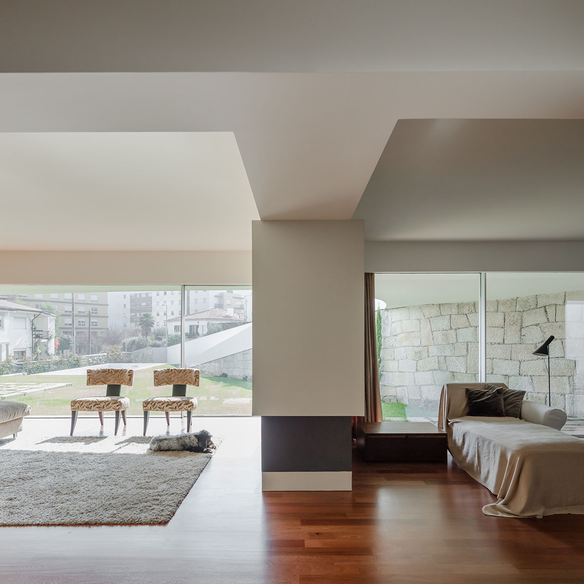 NOARQ designs smooth curvy-roof for Portuguese house to adapt to topography and create courtyards