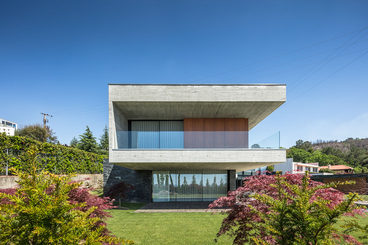 TRAMA Arquitetos completes v-shaped concrete house on hillside of Braga