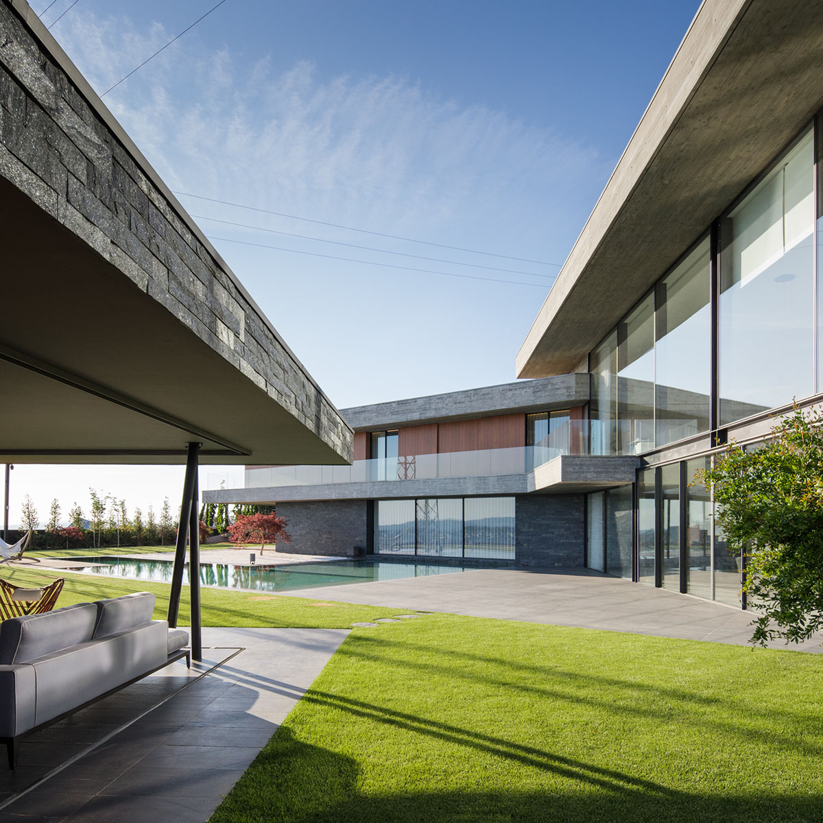 TRAMA Arquitetos completes v-shaped concrete house on hillside of Braga