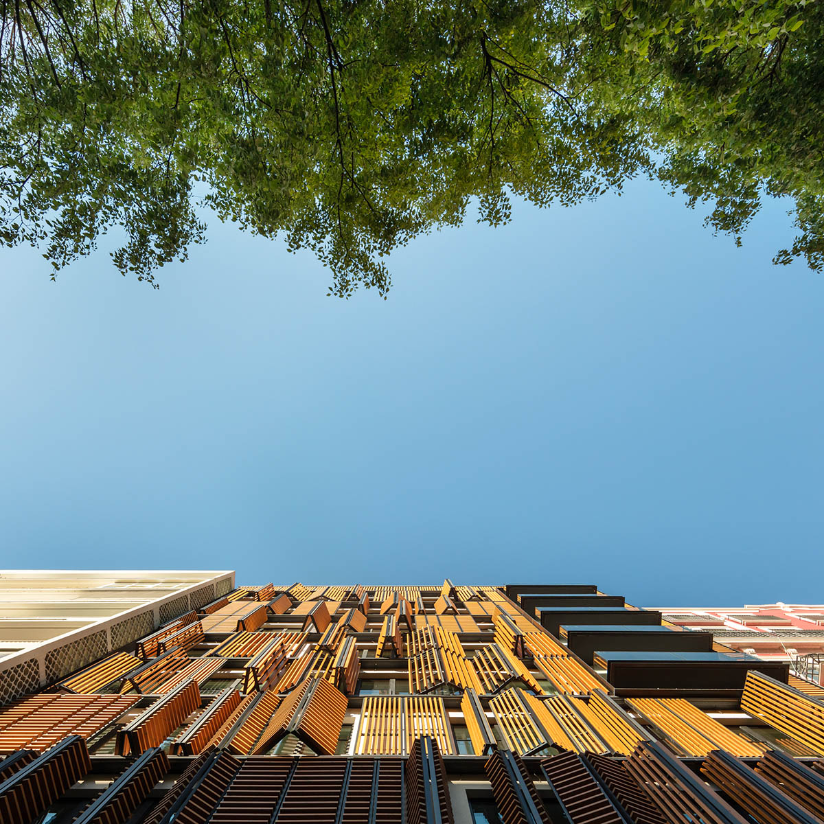Plano Humano Arquitectos creates dynamic building with automated wooden shutters in Lisboa