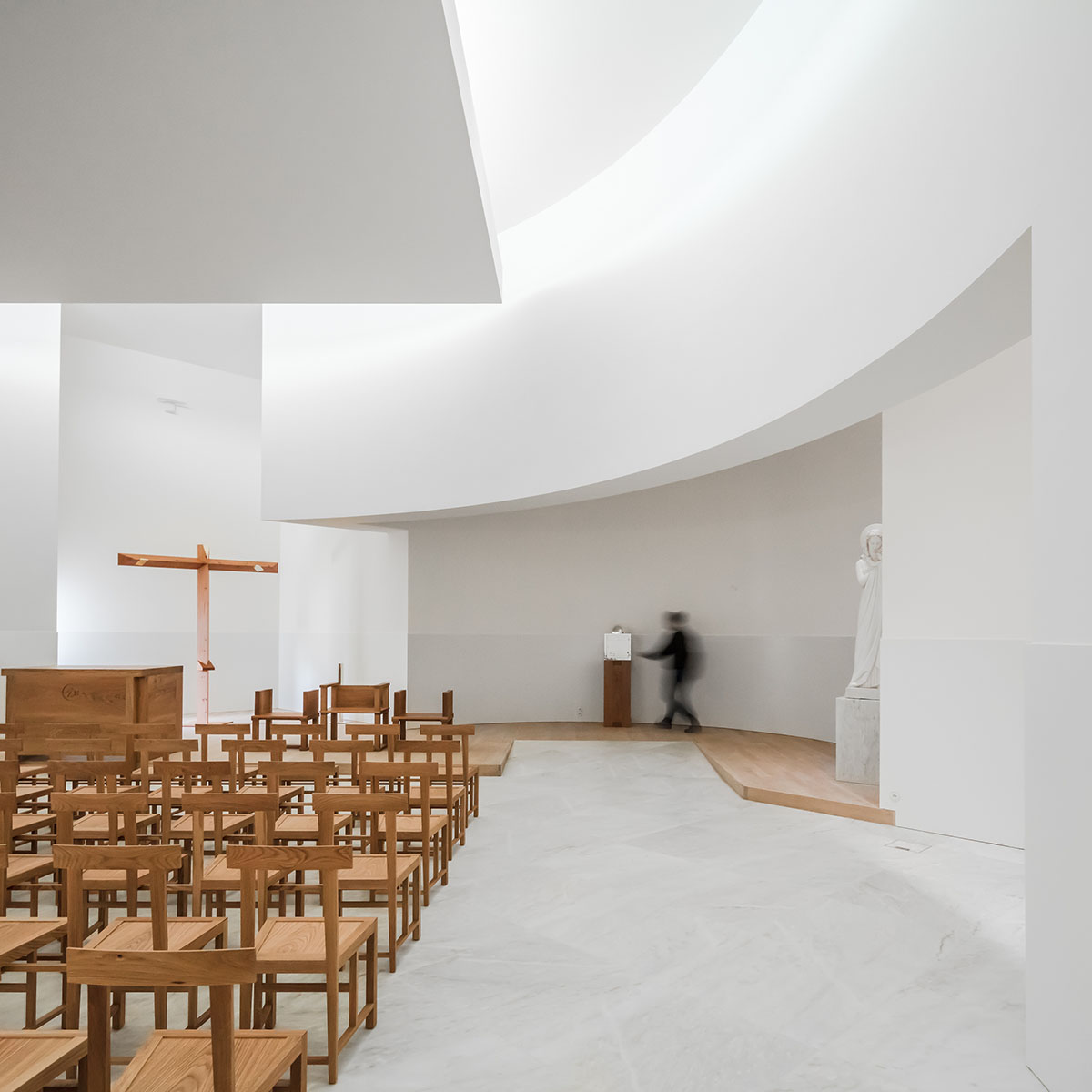 Álvaro Siza Completes His First Church In France with white coloured interlocking concrete volumes