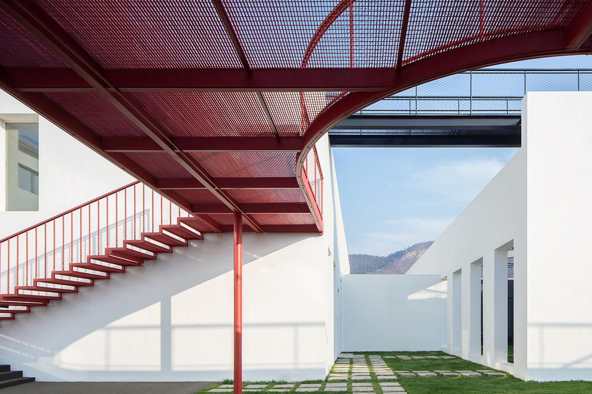 REDe Architects and Moguang Studio add red circular platform to renovated youth activity center