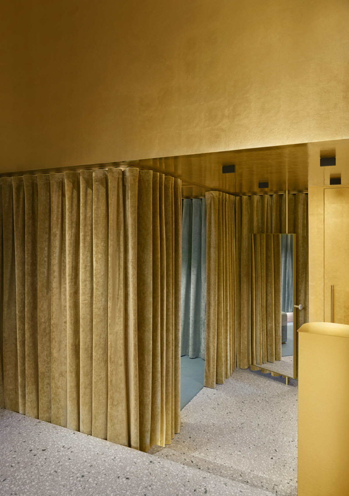Golden and powder-colored details dominate forte_forte forte dei Marmi boutique in Italy